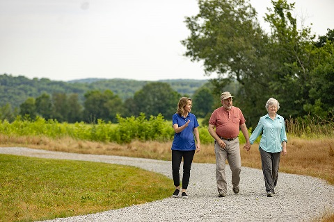 Couple walks gravel path with loan officer