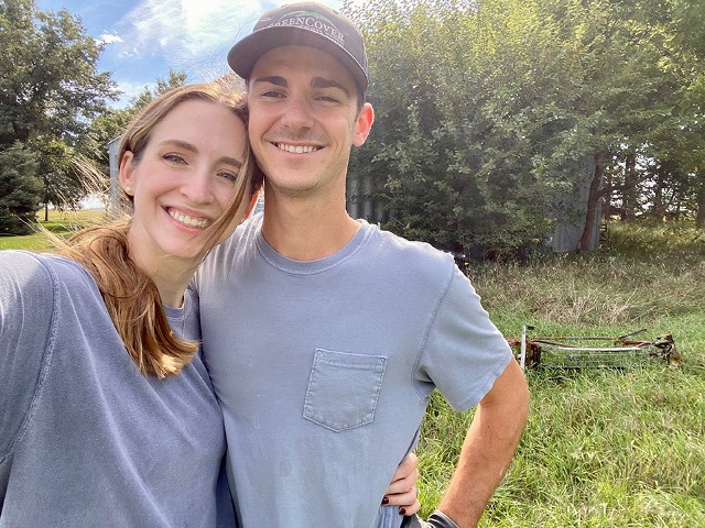 Young couple smiling happily after realizing their farm dream.