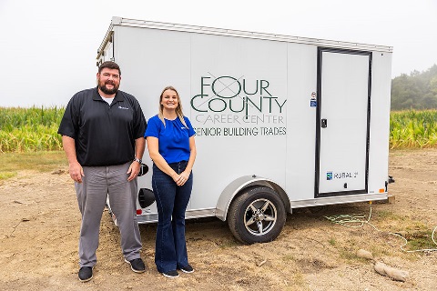 Loan officers in front of the Four County Career Center construction trailer