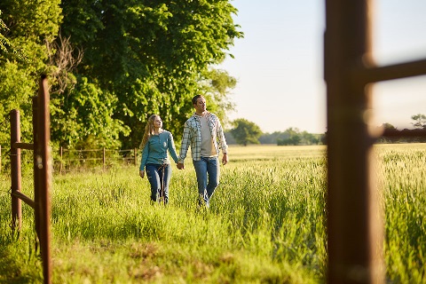 Couple walks on land financed by Rural 1st in Kansas