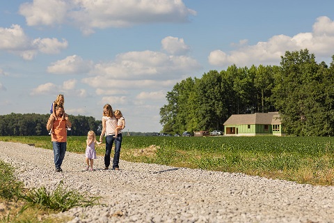 Family walks on gravel path of construction project financed by Rural 1st in Ohio