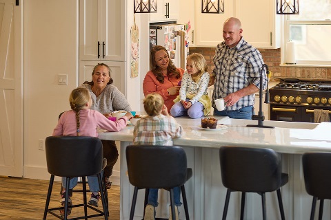 Family eats inside kitchen of rural home financed by Rural 1st in Colorado.