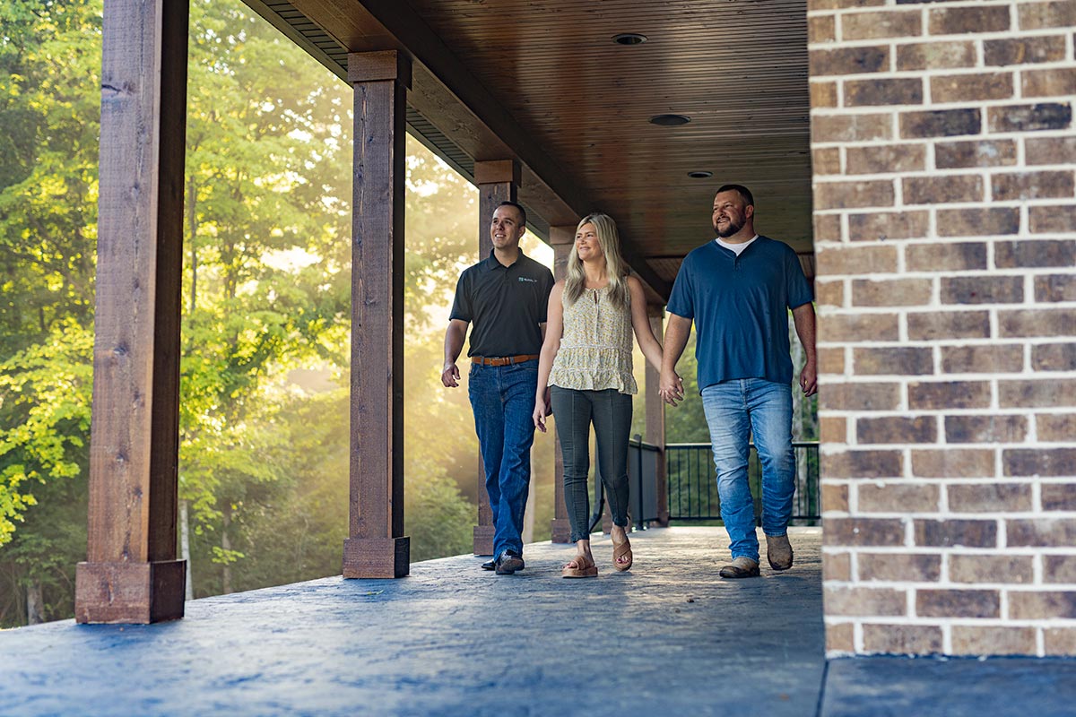 Couple walks with loan officer discussing bridge loans