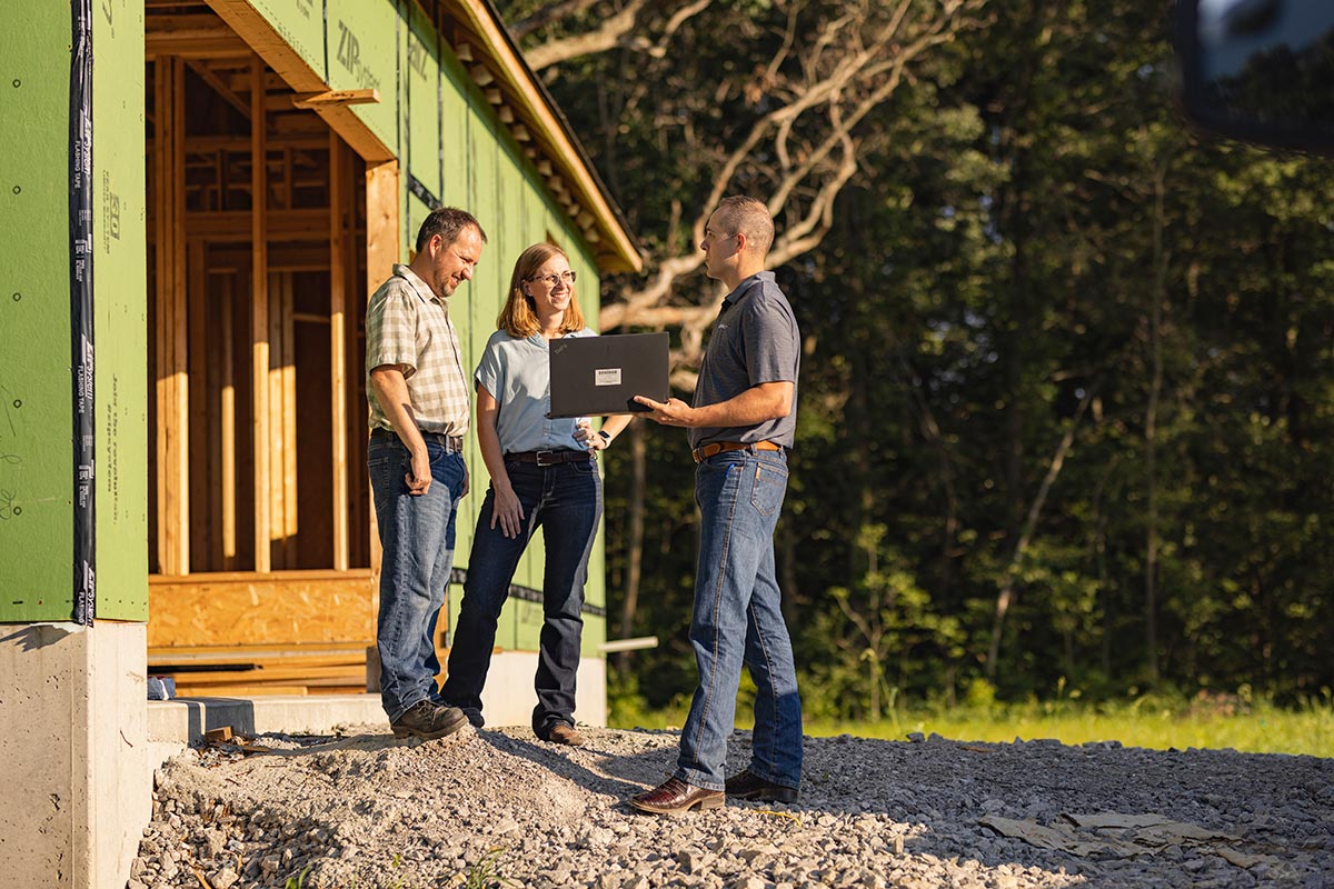 Loan officer helps customer with loan payments at a jobsite