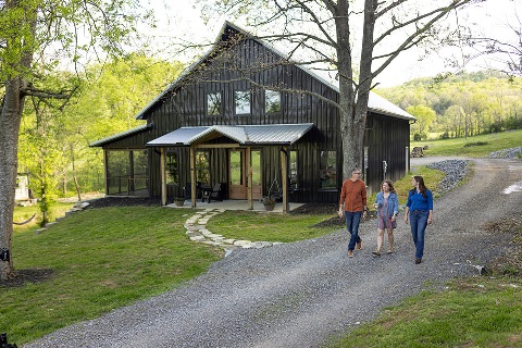 Wohelski Family walks past their barndo with loan officer