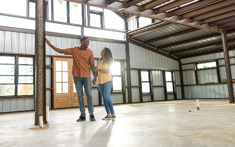 A couple inside their under construction barndo.