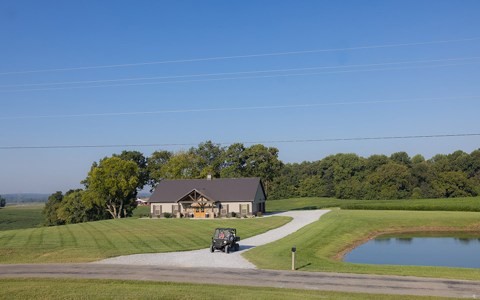 A utility vehicle driving down the driveway of a newly built rural home in Tennessee.