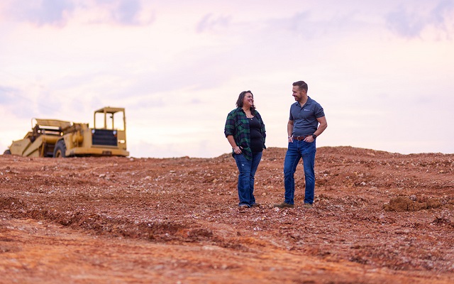 A woman and her Rural 1st loan officer chatting about the construction plans for her rural property.