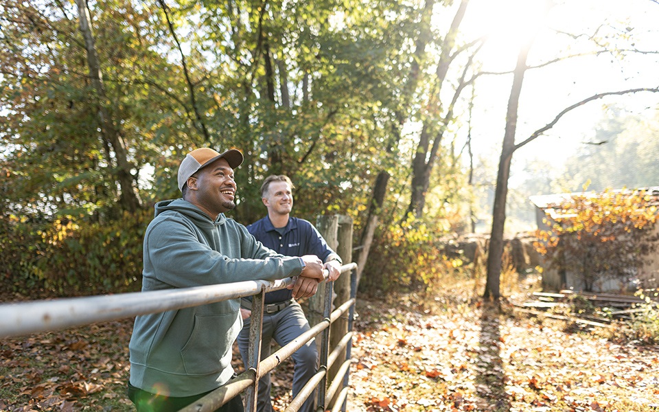 A man and his Rural 1st loan officer admiring his rural property.