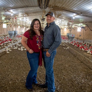 Woman and man in broiler house.