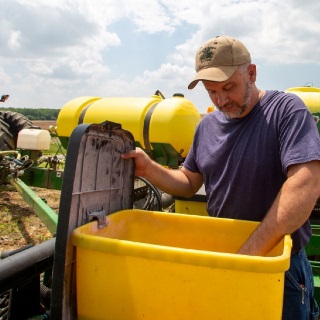 Farmer inspecting his planter.