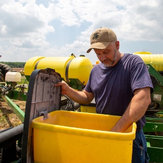 Farmer checks his planter.